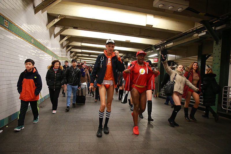 Participants of the No Pants Subway Ride head towards a connecting train in New York City, Sunday, Jan. 8, 2017. The 'No Pants Subway Ride' is an annual event that has become a global celebration of bare thighs. The 'celebration of silliness' is designed to make other subway riders smile. (Gordon Donovan/Yahoo News)