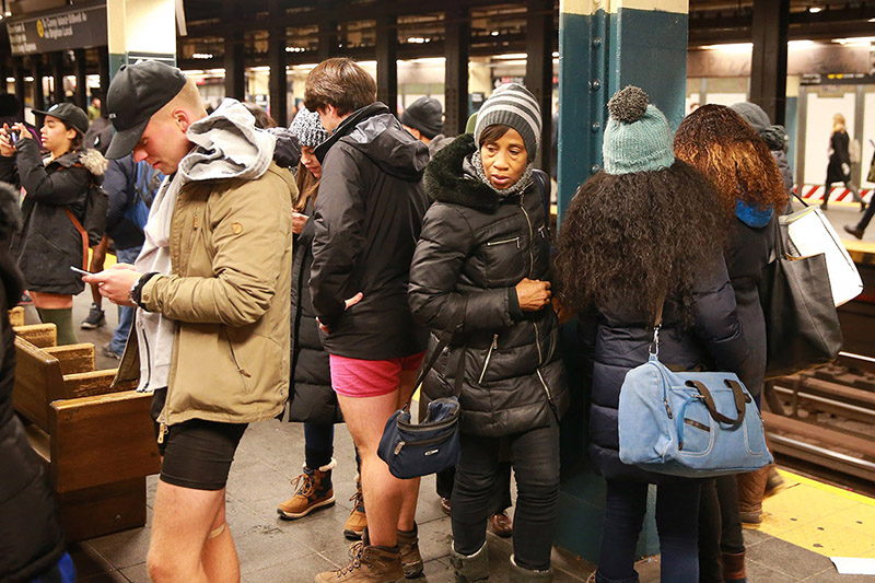 A passengers checks out a participant in the No Pants Subway Ride in New York City, Sunday, Jan. 8, 2017. The No Pants Subway Ride began in 2002 in New York as a stunt and has taken place in cities around the world since then. (Gordon Donovan/Yahoo News)