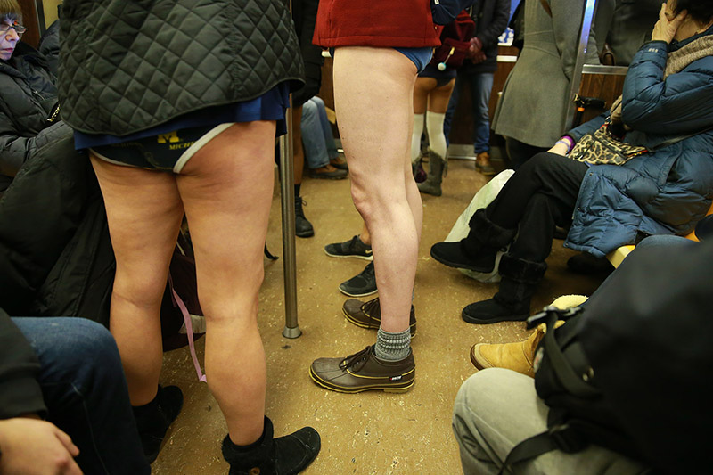 Passengers try to block out people take art taking part in the No Pants Subway Ride in New York City, Sunday, Jan. 8, 2017. The 'No Pants Subway Ride' is an annual event that has become a global celebration of bare thighs. The 'celebration of silliness' is designed to make other subway riders smile. (Gordon Donovan/Yahoo News)