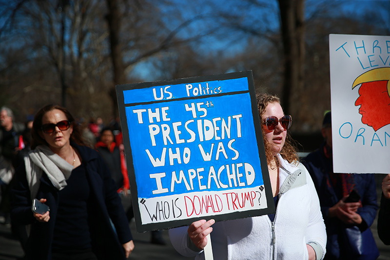 A demonstrator holds up a sign during the "Not My President's Day" rally on Central Park West in New York City on Feb. 20, 2017. (Gordon Donovan/Yahoo News)