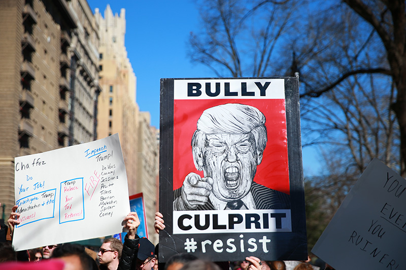 Demonstrator carries an anti-Trump sign during the “Not My President’s Day” rally at Central Park West in New York City on Feb. 20, 2017. (Gordon Donovan/Yahoo News)