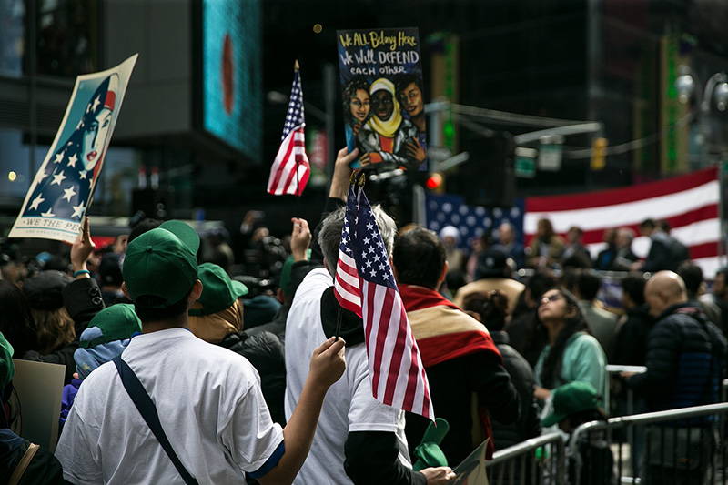 People show support waving U.S. flags in Times Square, New York City during the “I am a Muslim too" rally on Feb. 19, 2017. (Gordon Donovan/Yahoo News)