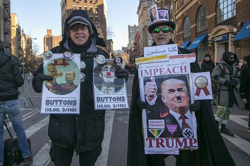 Two men sell buttons at a rally in front of the Stonewall Inn in solidarity with immigrants, asylum seekers, refugees, and the LGBT community, Feb. 4, 2017 in New York. (Photo: Gordon Donovan/Yahoo News)