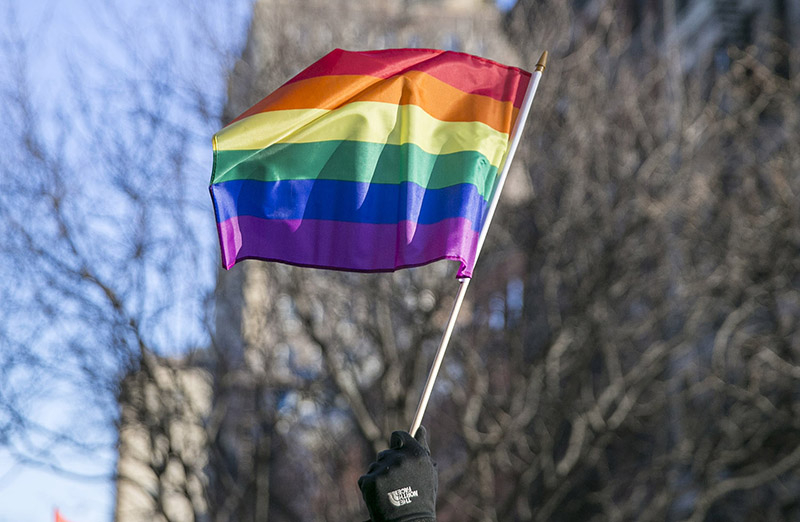 A person waves a rainbow flag at a rally in front of the Stonewall Inn in solidarity with immigrants, asylum seekers, refugees, and the LGBT community, Feb. 4, 2017 in New York. (Photo: Gordon Donovan/Yahoo News)