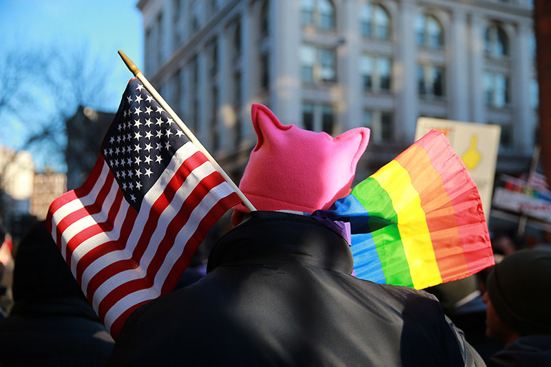 A protester wears a rainbow and U.S. flags at a rally in front of the Stonewall Inn in solidarity with immigrants, asylum seekers, refugees, and the LGBT community, Feb. 4, 2017 in New York. The demonstrators protested the policies of U.S. President Donald Trump. (Photo: Gordon Donovan/Yahoo News)