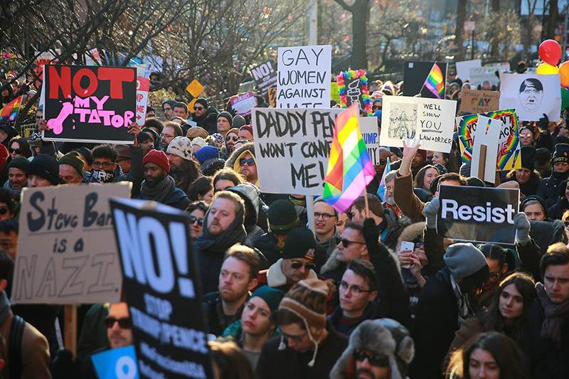 People hold signs and flags at a rally in front of the Stonewall Inn in solidarity with immigrants, asylum seekers, refugees, and the LGBT community, Feb. 4, 2017 in New York. (Photo: Gordon Donovan/Yahoo News)
