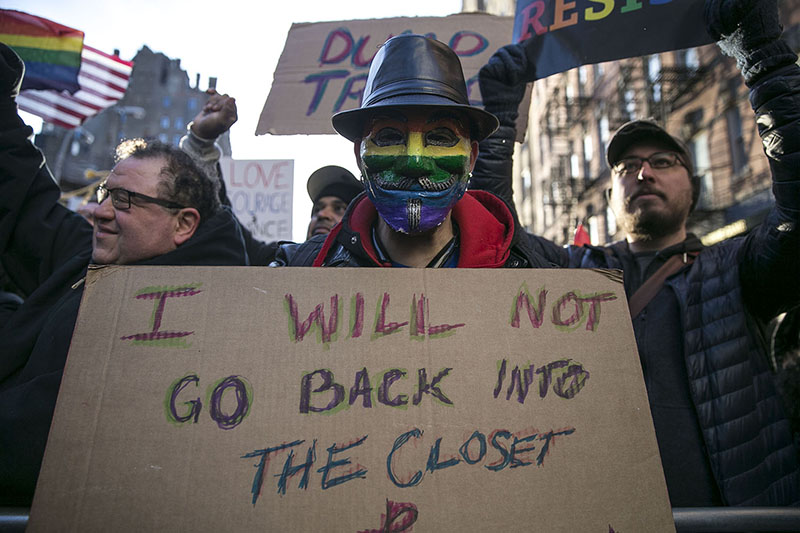 A protest wears a Guy Fawkes mask in rainbow colors at a rally in solidarity with immigrants, asylum seekers, refugees, and the LGBT community, Feb. 4, 2017 in New York. (Photo: Gordon Donovan/Yahoo News)
