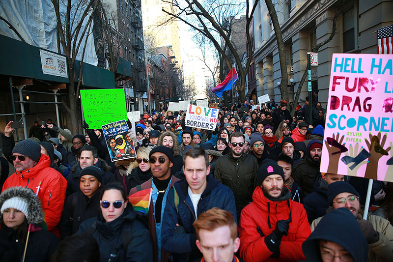 People hold signs and flags at a rally in solidarity with immigrants, asylum seekers, refugees, and the LGBT community, Feb. 4, 2017 in New York. (Photo: Gordon Donovan/Yahoo News)