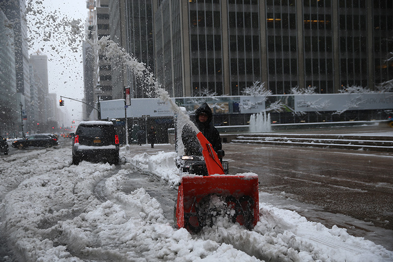 A worker plows snow outside commercial buildings on Park Avenue in New York City after a winter storm on Feb. 9, 2017. (Gordon Donovan/Yahoo News)