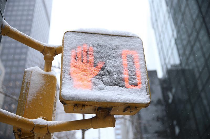 A walk sign is down to zero is covered in snow on Park Avenue in New York City during a winter storm on Feb. 9, 2017. (Gordon Donovan/Yahoo News)