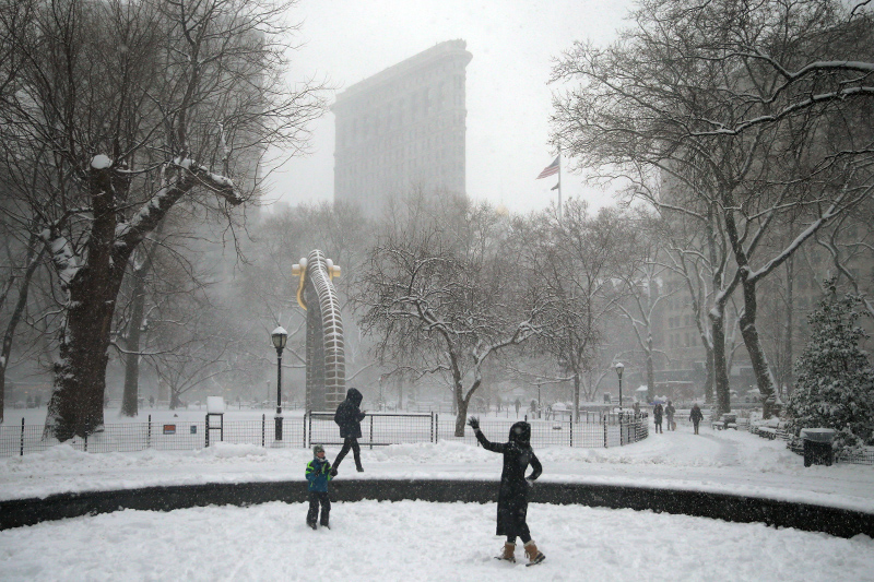 People enjoy the snow in Madison Square Park during a winter storm on Feb. 9, 2017, in New York. (Gordon Donovan/Yahoo News)