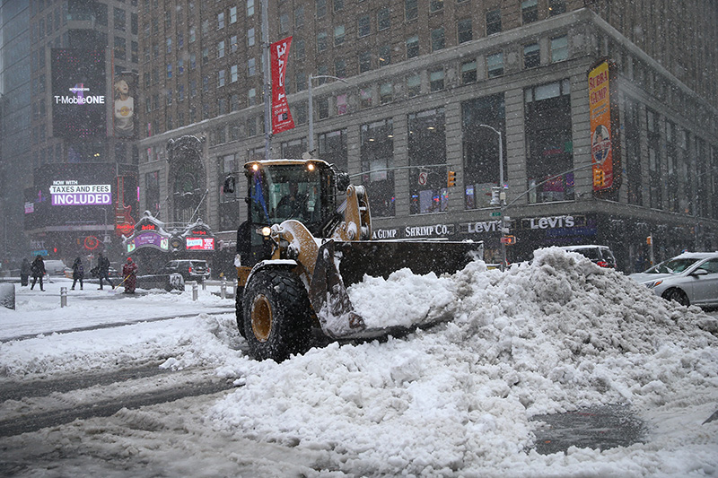 A bulldozer piles up snow in Times Square in New York City after a winter storm on Feb. 9, 2017. (Gordon Donovan/Yahoo News)