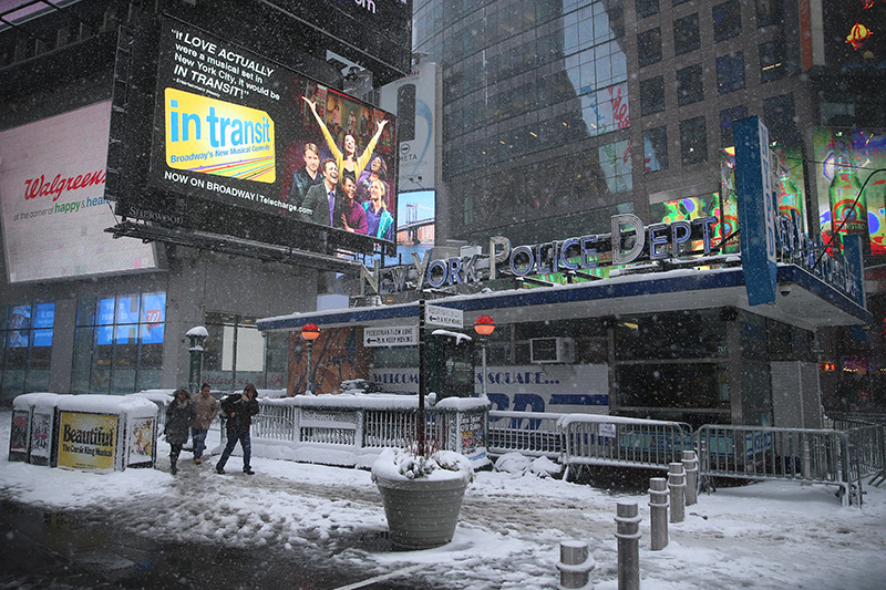 People head out from subway into snow in Times Square during a winter storm in New York City on Feb. 9, 2017. (Gordon Donovan/Yahoo News)