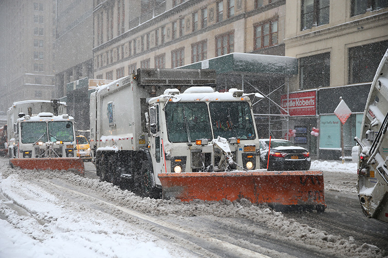 New York City Sanitation trucks plow along E. 42nd Street near Grand Central Terminal in New York on Feb. 9, 2017. (Gordon Donovan/Yahoo News)