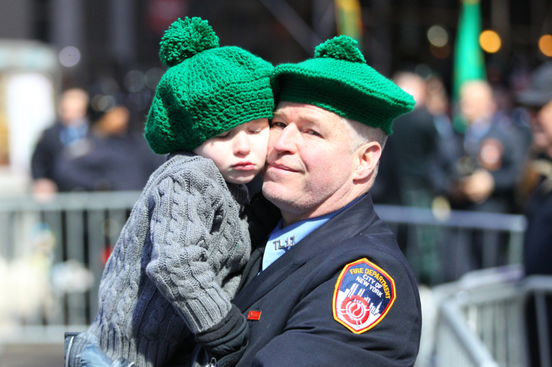 A member of the New York City Fire Department embraces his son while watching the St. Patrick's Day Parade, March 17, 2017, in New York. (Gordon Donovan/Yahoo News)