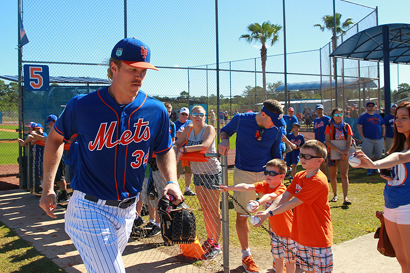 New York Mets picther Noah Syndergaard jogs past fans holding baseballs after a live bullpen at the New York Mets spring training facility in Port St. Lucie, Fl., Saturday, Feb 25, 2017. (Gordon Donovan/Yahoo Sports)