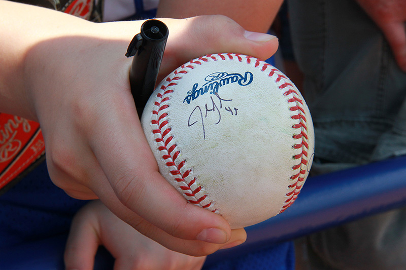 A fans holds a ball signed by a player before the baseball game between the Washington Nationals and New York Mets at First Data Field in Port St. Lucie, Fl., Saturday, Feb 25, 2017. (Gordon Donovan)
