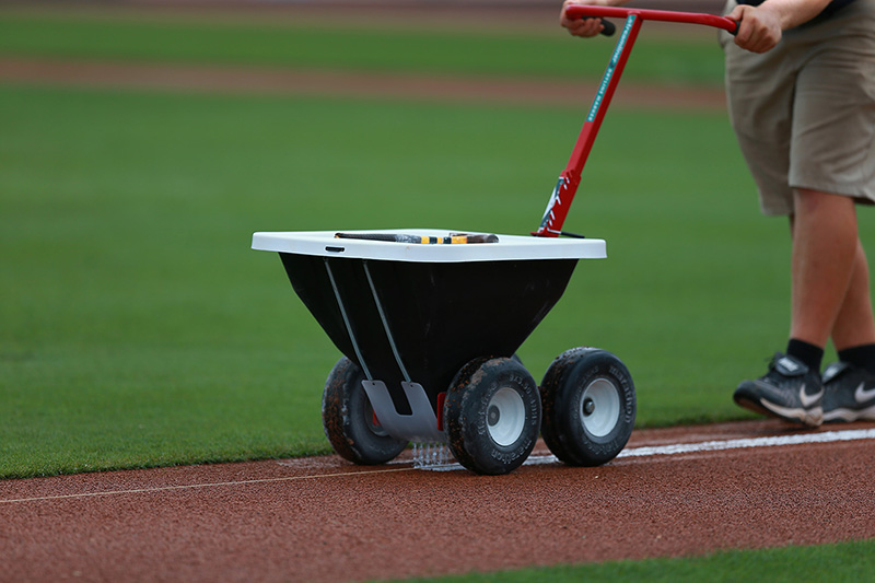 A grounds crew member prepares the 3rd base line before the spring training baseball game against the New York Mets and St. Louis Cardinals at Roger Dean Stadium in Jupiter, Fl., Wednesday, March 1, 2017. (Gordon Donovan/Yahoo Sports)