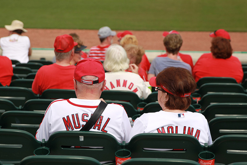 Fans wearing jerseys with late Hall of Famer Stan Musial and current Cardinal Yadier Molina sit in seats before a spring training baseball game between the New York Mets and St. Louis Cardinals at Roger Dean Stadium in Jupiter, Fl., Wednesday, March 1, 2017. (Gordon Donovan/Yahoo Sports)