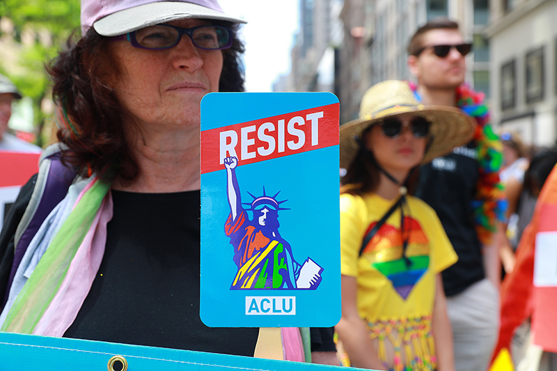 A woman holds up a resist signs before the start of the N.Y.C. Pride Parade in New York on June 25, 2017. (Photo: Gordon Donovan/Yahoo News)